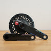 Bicycle crankset with chainring on a wooden surface