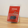 SRAM battery in its original red and clear blister packaging, standing on a wooden surface against a plain light background.