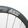 Close-up of a dark gray carbon fiber bicycle wheel rim with the white and gray ZIPP 303 Firecrest branding, set against a plain white background.