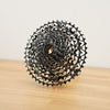 A silver SRAM Rival cassette photographed on a light wooden surface against a plain white backdrop.