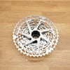 A silver SRAM Rival cassette photographed on a light wooden surface.